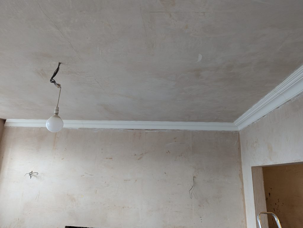 Decorative plaster cornice installed on straight wall section