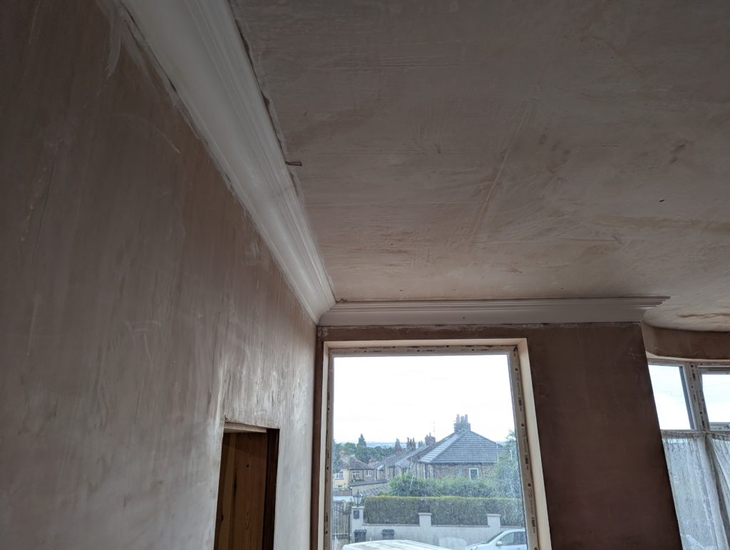 Decorative plaster cornice installed in room corner
