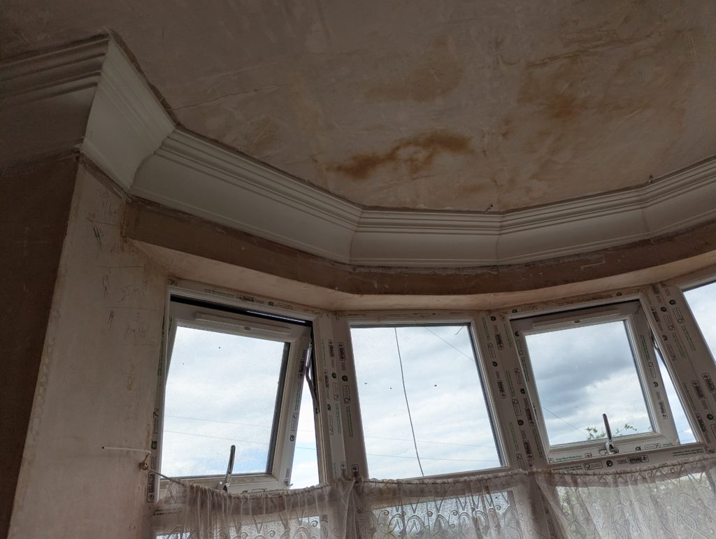 Decorative plaster cornice installed around bay window