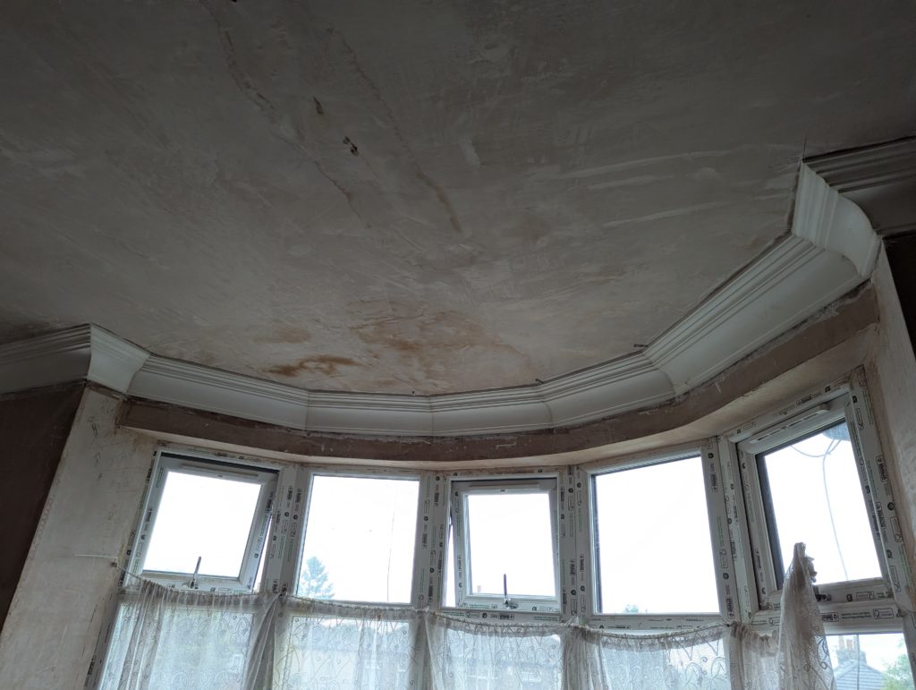 Decorative plaster cornice installed around bay window